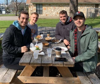 Four friends at picnic table