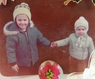 Brother and sister as children holding hands