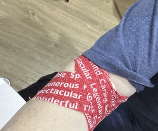 Arm with red pressure bandage