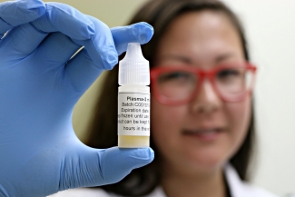 Tamiko Stewart holding a vial of plasma eye drops