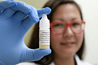 Tamiko Stewart, project lead at Canadian Blood Services' Centre for Innovation, holds a filled bottle of plasma eye drops.