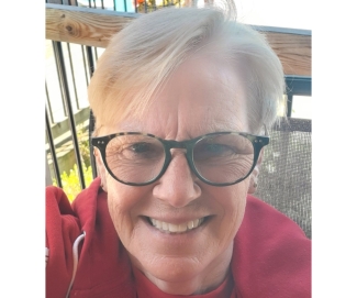 Blood and kidney donor in red hoodie and glasses smiling