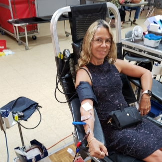 Blood donor in chair donating blood