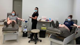 Samantha Cook, left, and her sister Jeanne Cook, right, became first-time blood donors in June