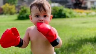 Jakob Guziak entertains his family in his new boxing gloves.