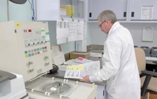 James McCarroll, a medical laboratory technician, examines some paperwork at Canadian Blood Services’ Concourse Gate facility in Ottawa.