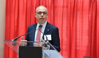 Graham Sher standing in behind a podium speaking at the 8th Annual Corporate Supporters’ Luncheon