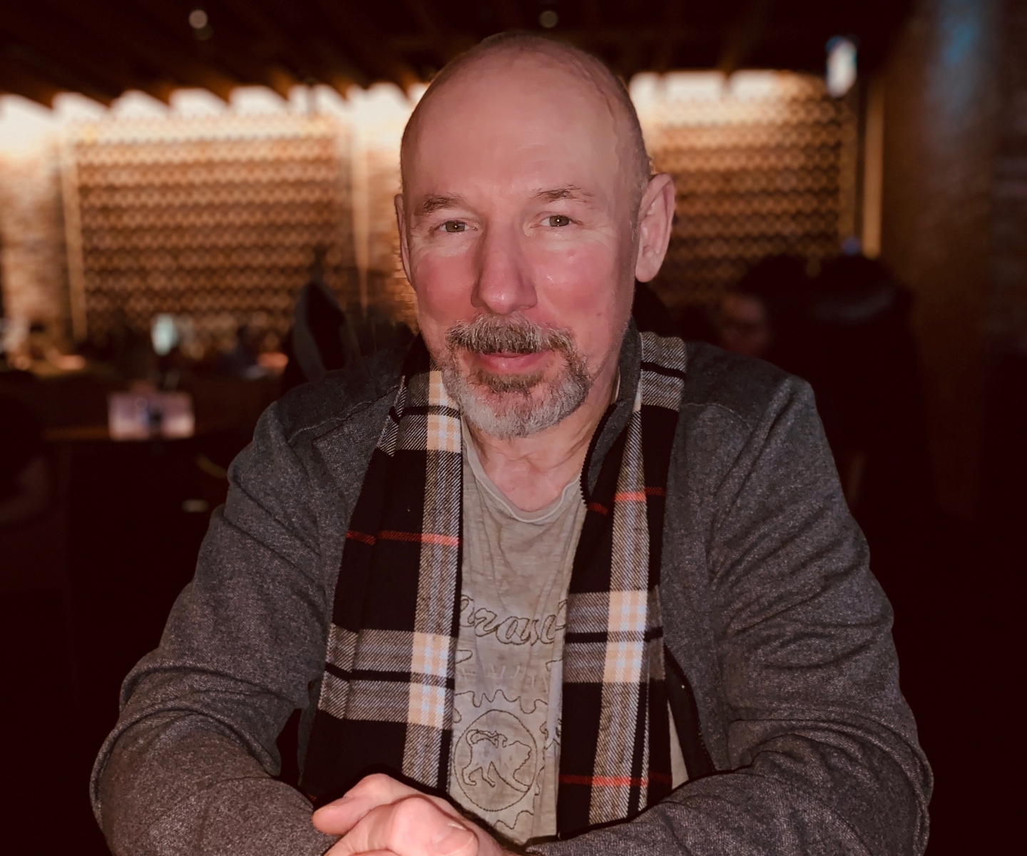 Man in scarf at table