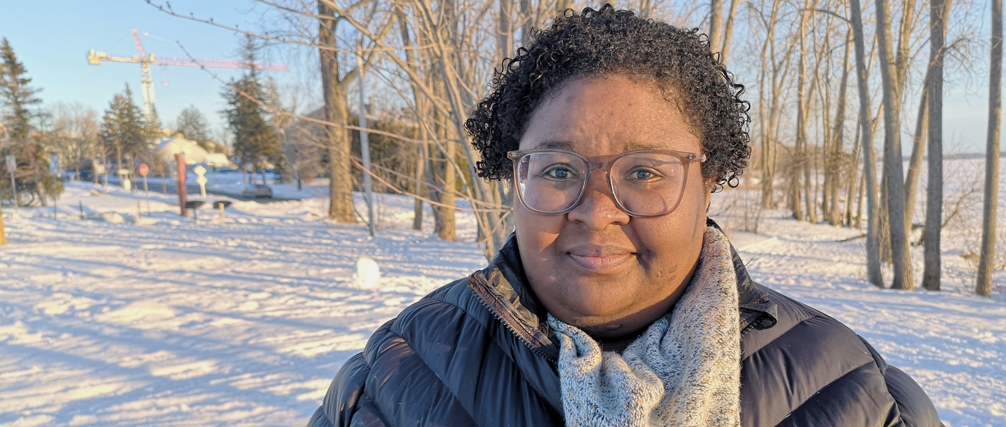 Élodie Guitteaud, a Black employee at Canadian Blood Services poses outside by the snow.