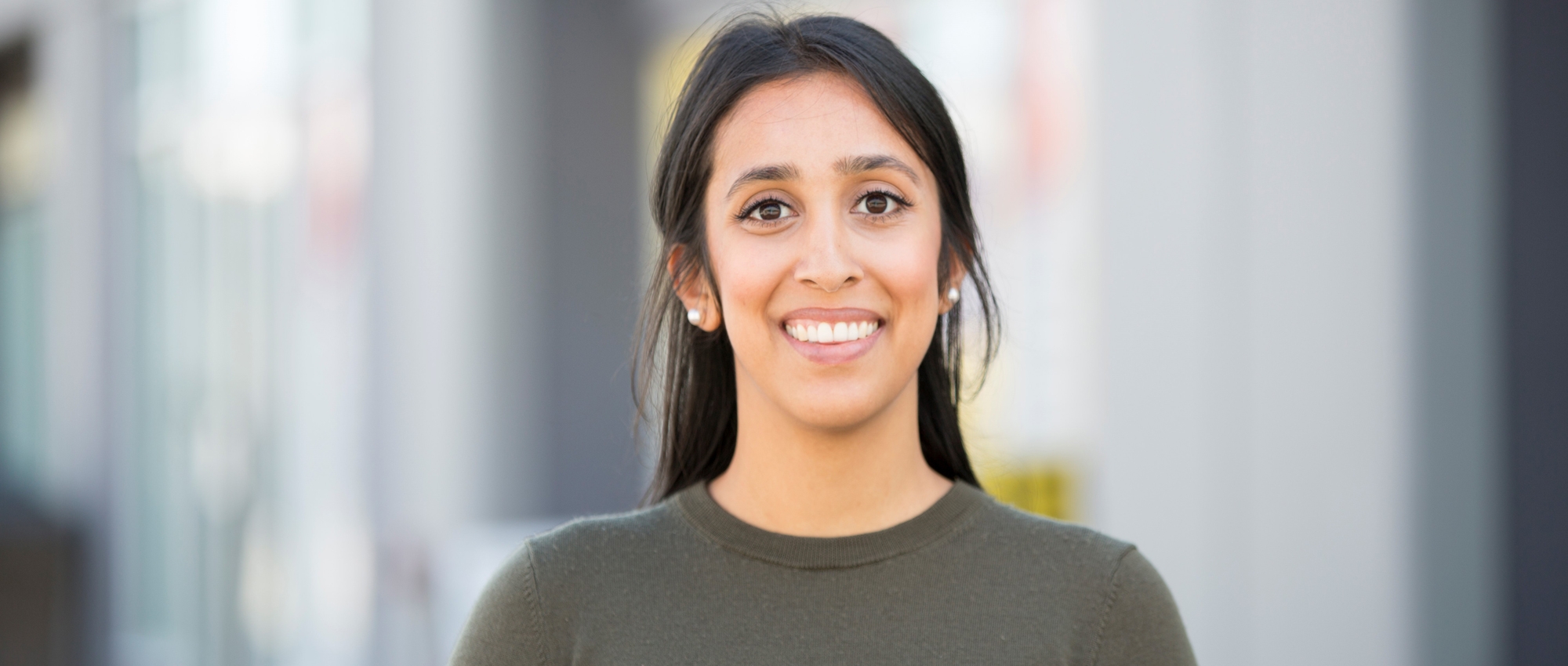 Jastej Sidhu, an Adult woman stands outside in front of a storefront