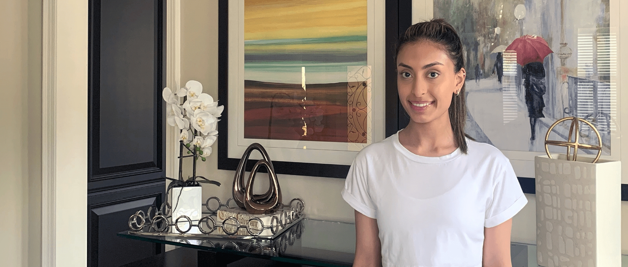 Woman in white T-shirt with paintings and white flowers