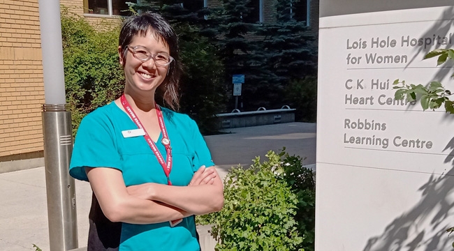 A cord blood specialist in scrubs on a hospital campus in Edmonton.