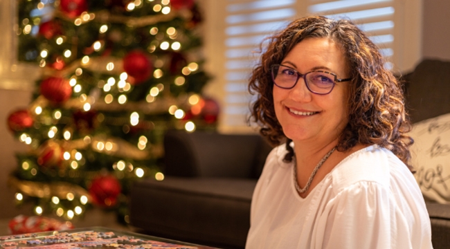 O-negative blood donor Julia Moore sits by a Christmas tree