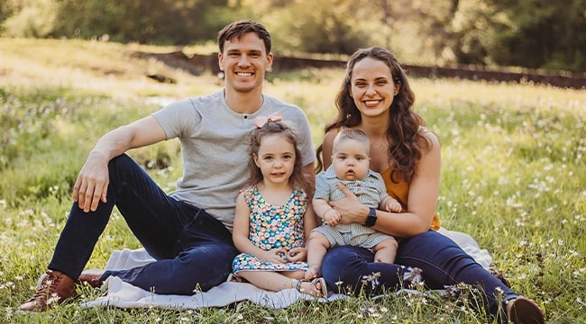 Stem cell recipient’s family sitting on the grass 