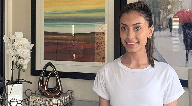 Woman in white T-shirt with paintings and white flowers